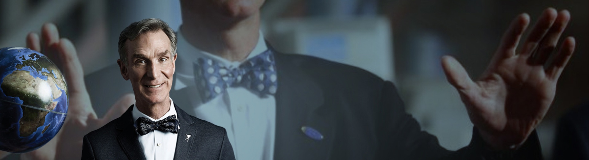 Bill Nye in a bow tie smiling in front of a background of himself, larger.
