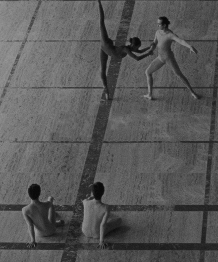 Black and white image of four dancers on the David H. Koch stage in NYC.
